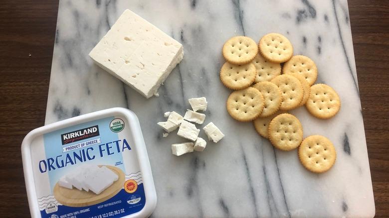 Kirkland Signature organic feta on a board with crackers.
