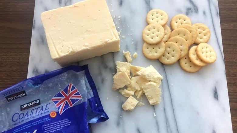 Kirkland Signature mature English cheddar on platter with crackers.