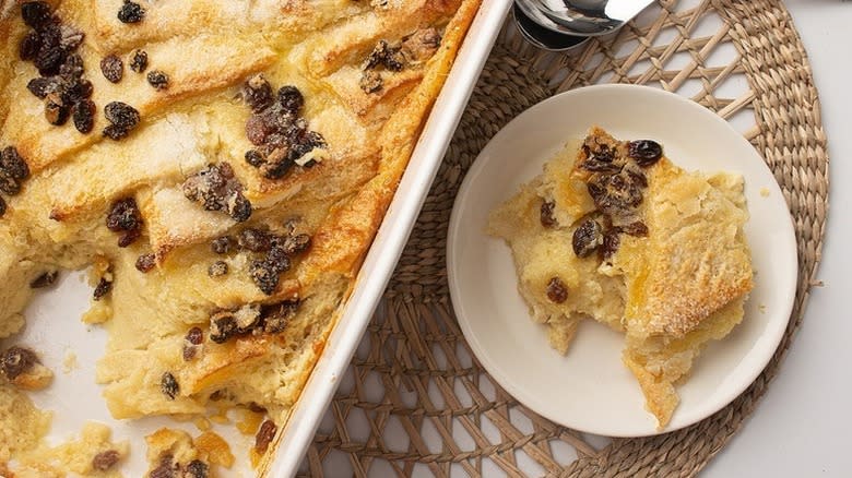 Bread and butter pudding served from baking dish onto plate