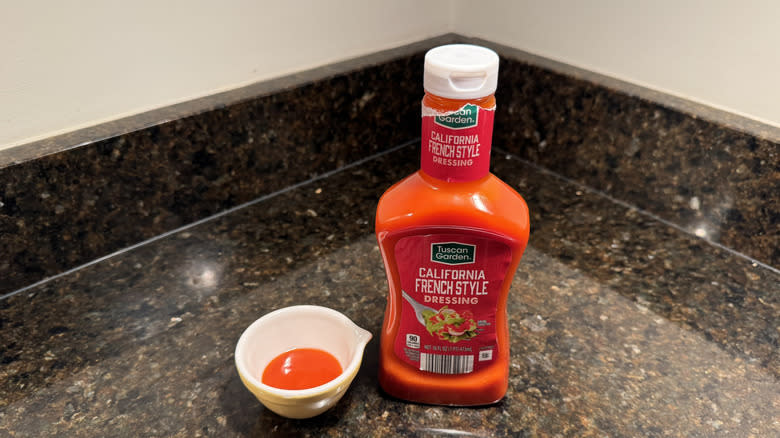 California French-Style dressing on countertop next to small white dish containing dressing