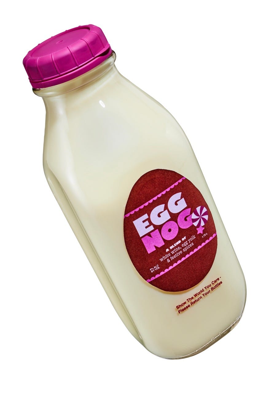 bottle of egg nog with a pink cap and a festive label