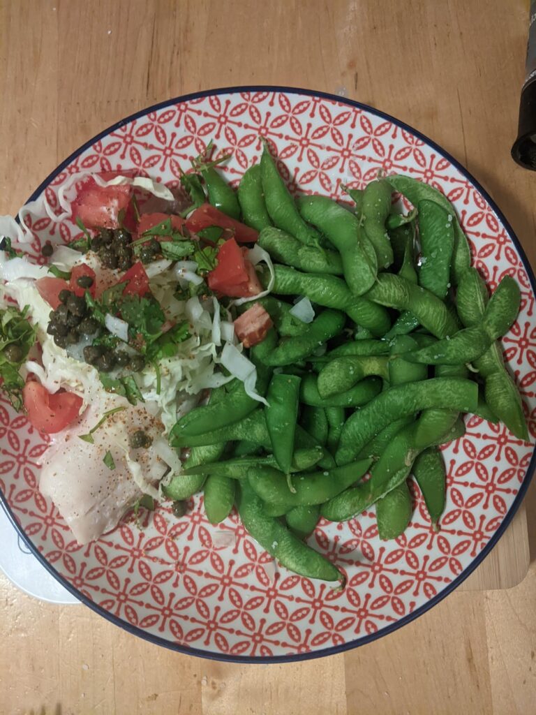 Baked tilapia topped with Greek yogurt, cabbage, tomato and capers. I also added a squeeze of lime and some tomatillo salsa. Big side of edamame.