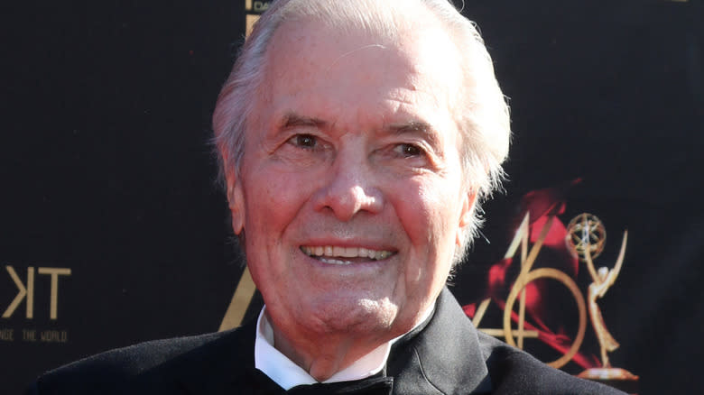 Jacques Pépin smiling in black with white shirt