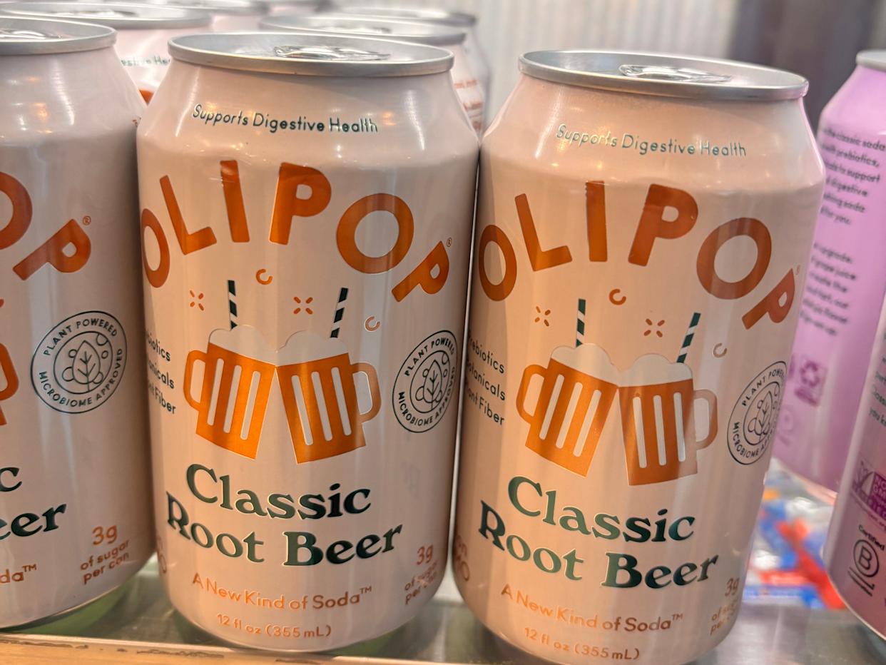 cans of olipop soda at the airport