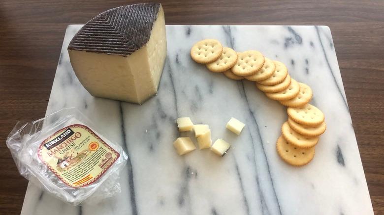 Kirkland Signature Manchego cheese on platter with crackers.