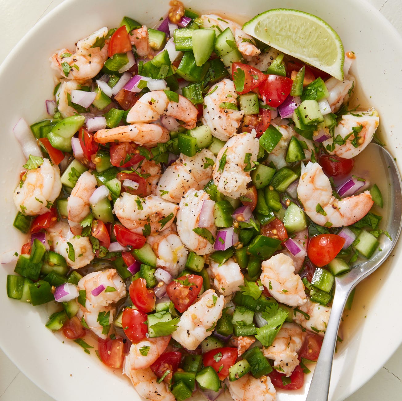shrimp ceviche with tomatoes, cucumbers and red onion