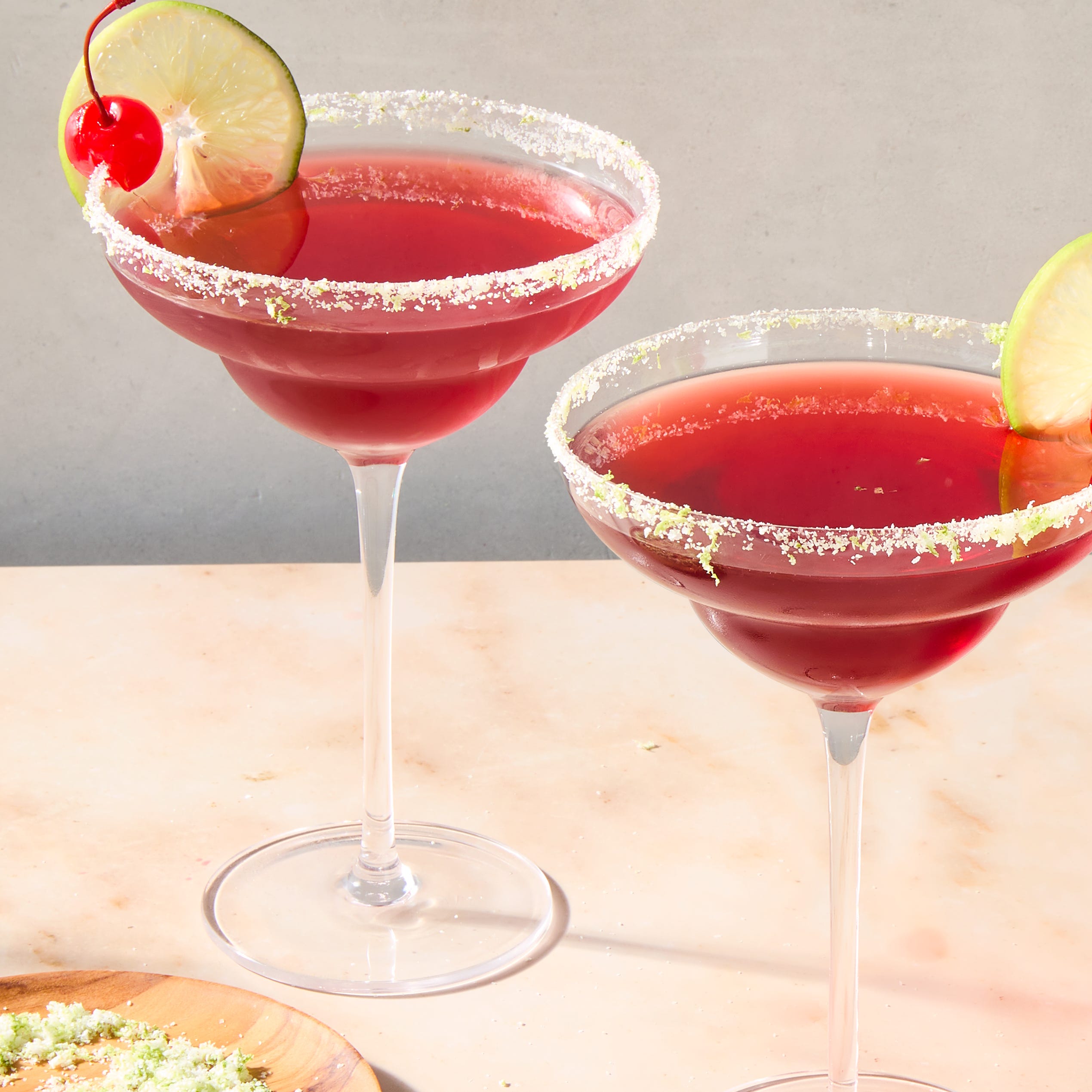 cherry lime margarita with a lime rim and cherry and lime garnish