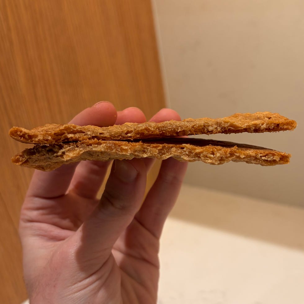 layered crispy snack held in hand