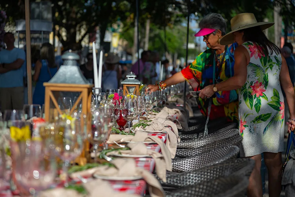 Attendees look at table arrangements at the Savor the Avenue eating event in downtown Delray Beach, Fla., on March 27, 2023.