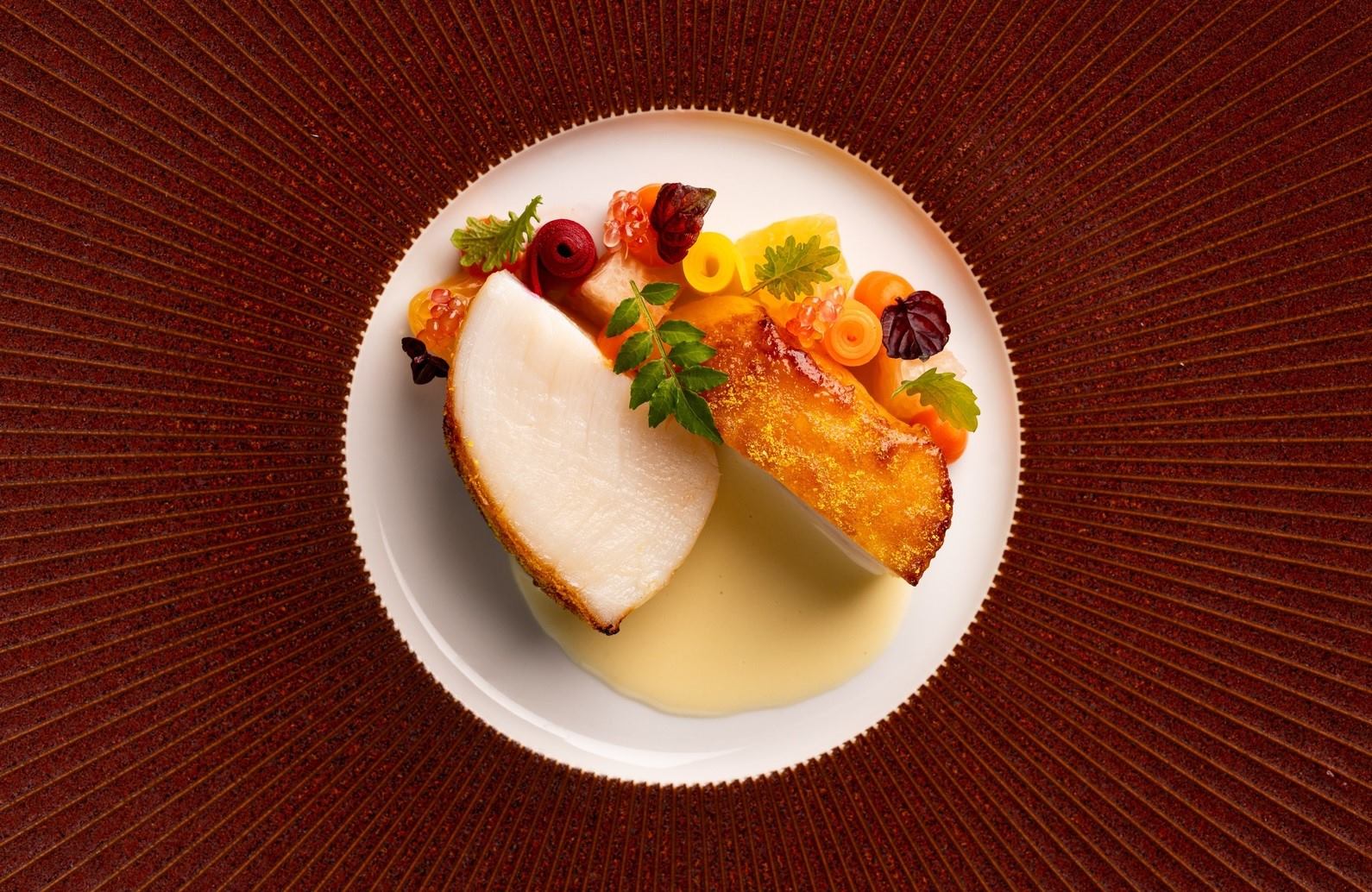 A beautifully presented scallop dish from Matt Abé's Two-MICHELIN-Star restaurant. © Bonheur by Matt Abé