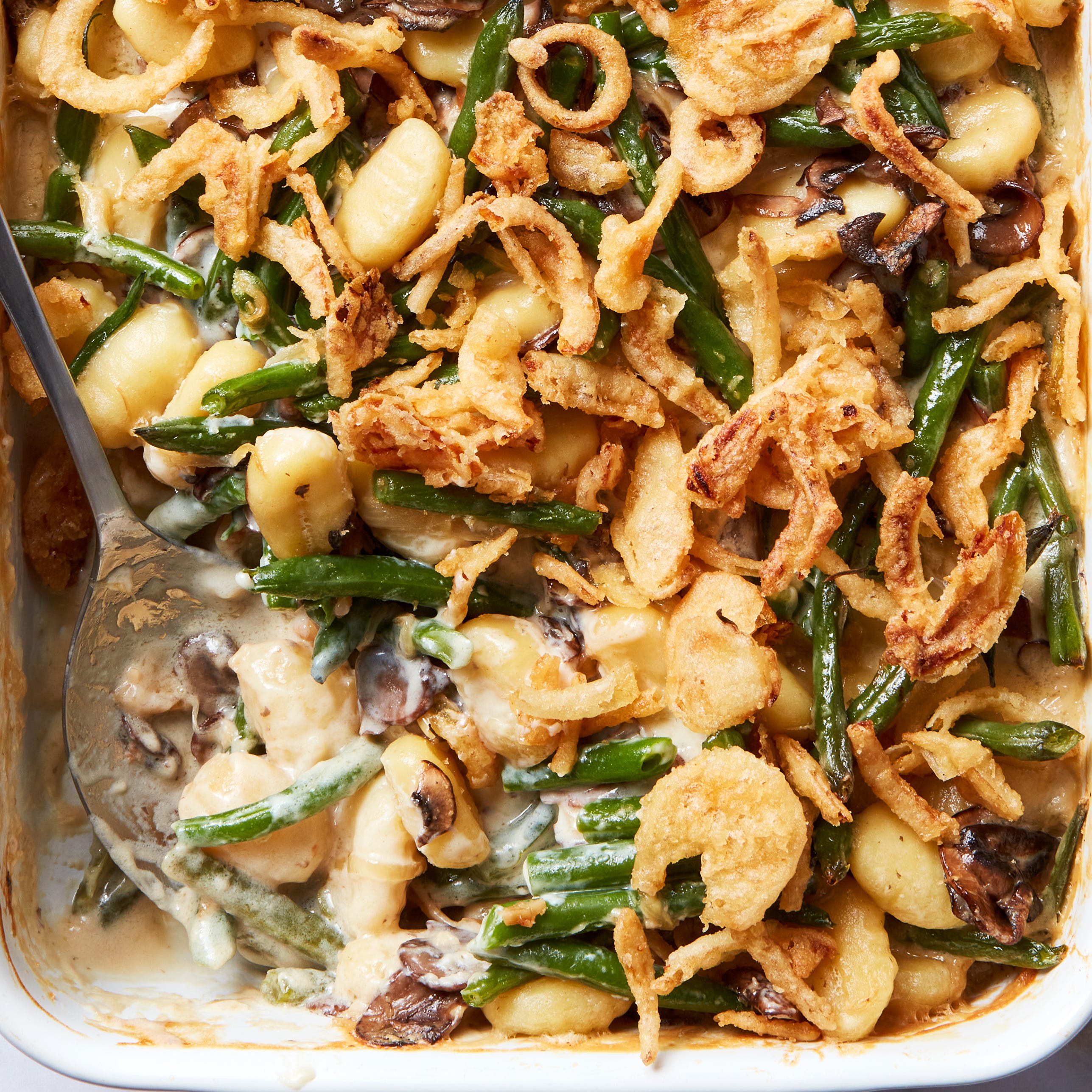 blanched fresh green beans and buttery sliced mushrooms, onions, and garlic get tossed with a creamy bechamel sauce and pillowy gnocchi then baked until bubbly