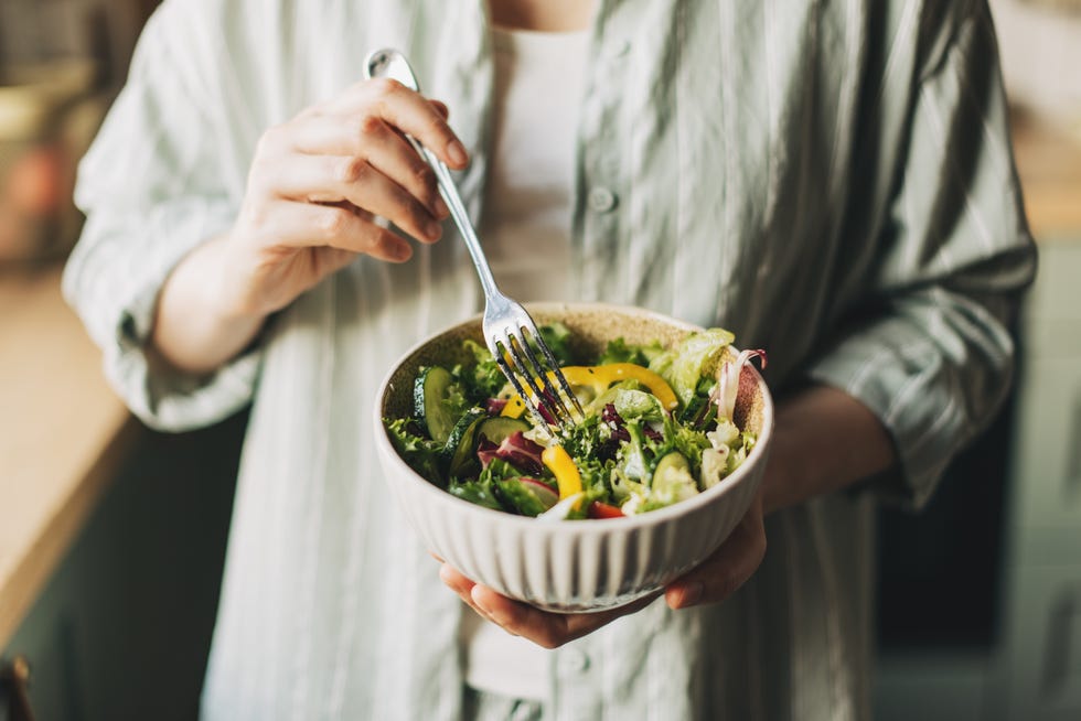 Woman holding bowl with products for heart-healthy diet, closeup
