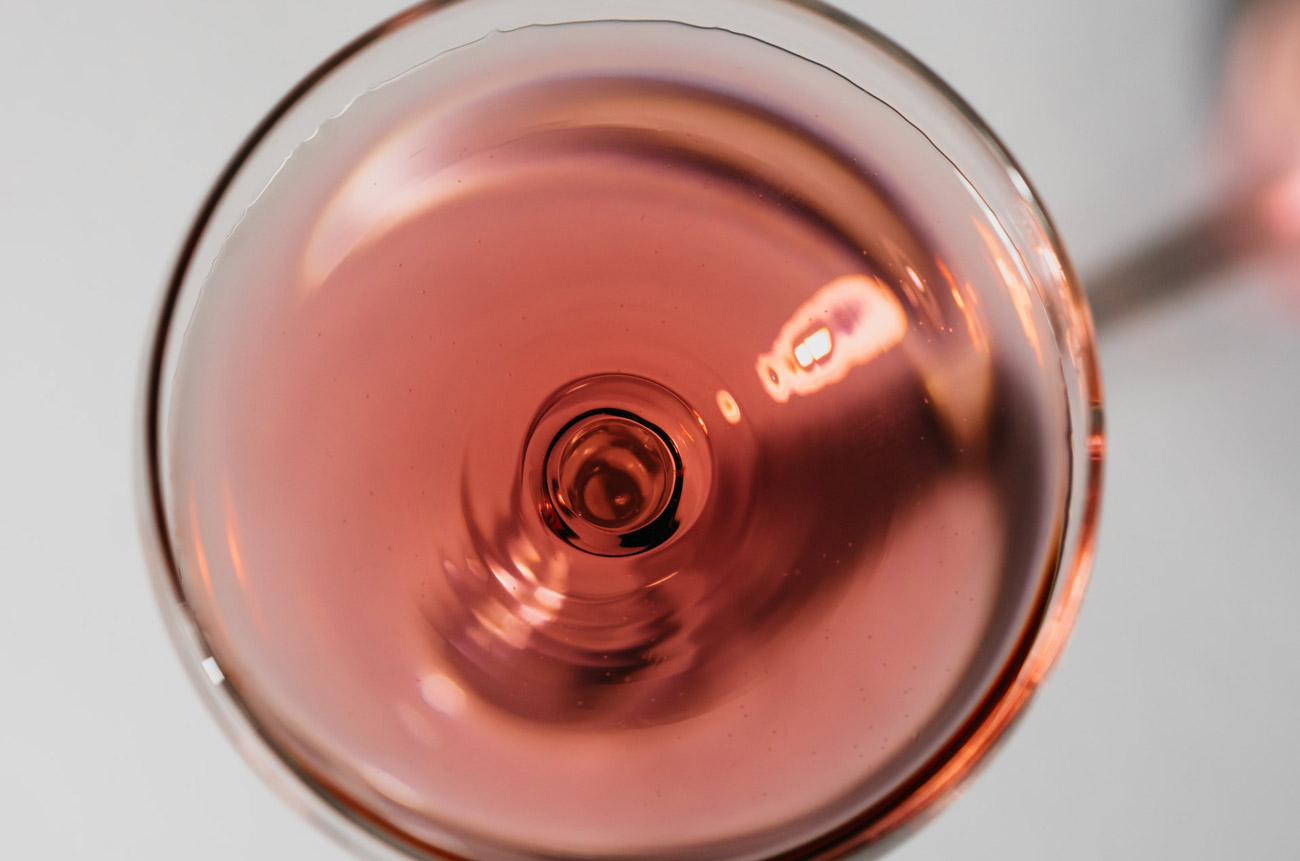 a glass of pink rose wine