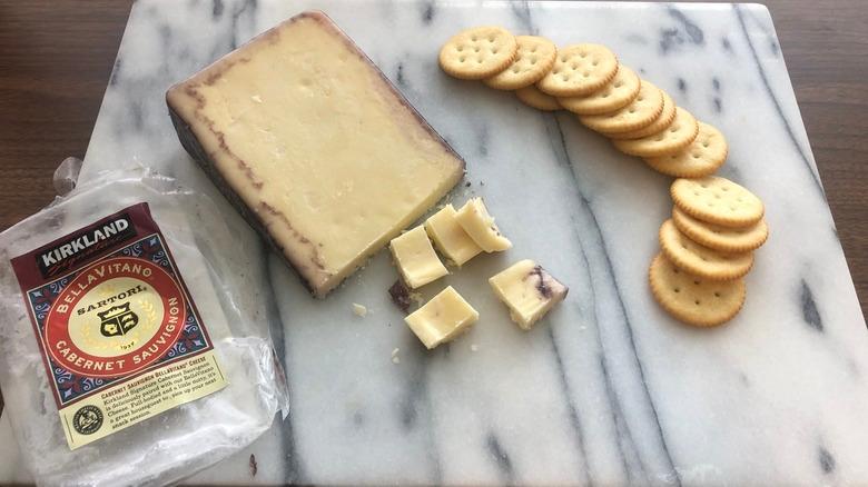 Kirkland Signature Sartori BellaVitano Cabernet Sauvignon cheese on platter with crackers.