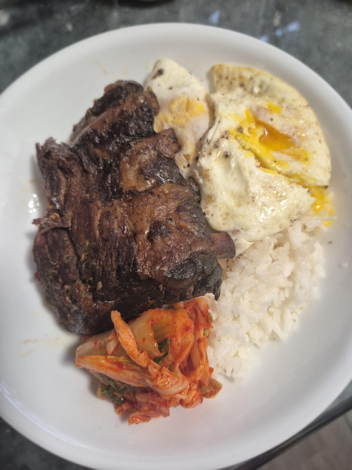 Eggs over rice with ribs & kimchi