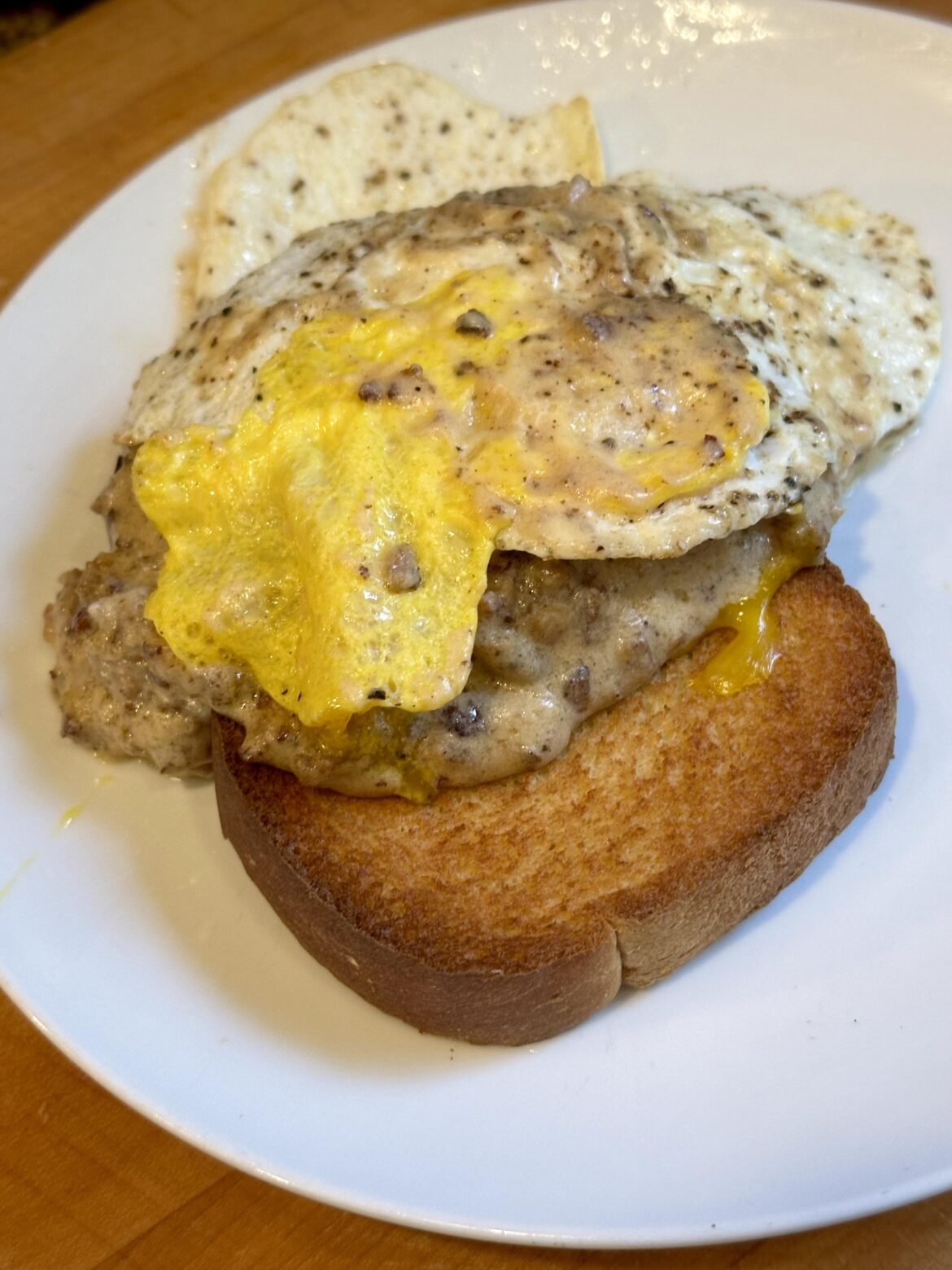 Fried Egg on top of Sausage Gravy and Toast