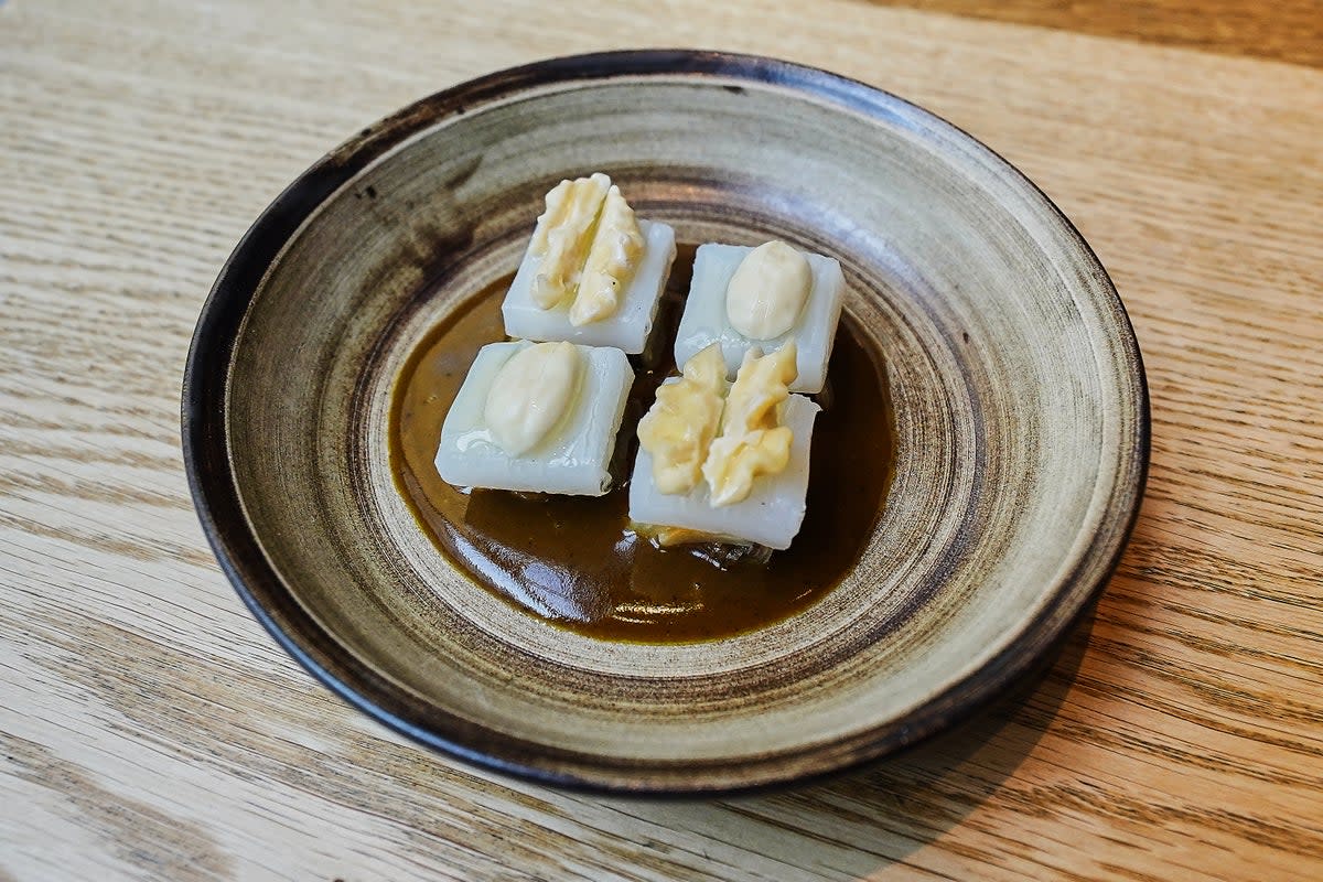 A cured squid, white cabbage, hazelnuts and walnuts dish served at restaurant Kadeau (AP)