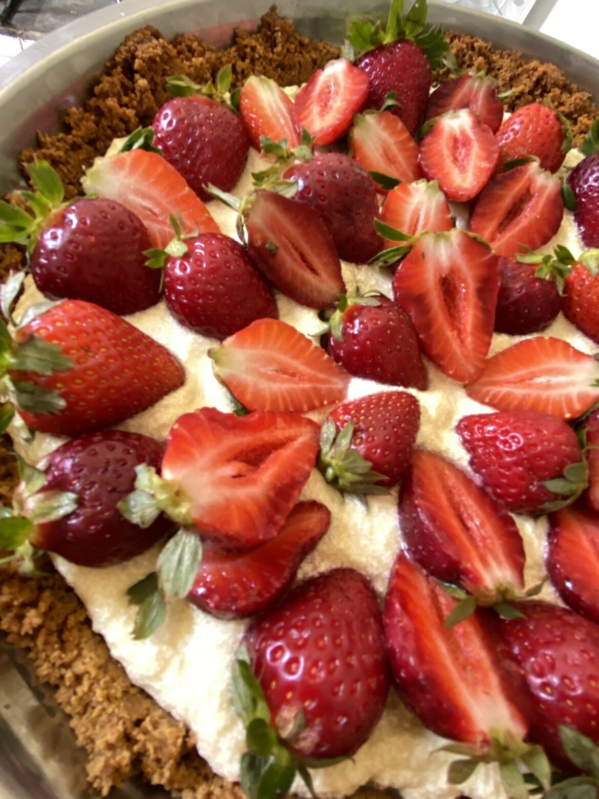 A cheesecake with lots of strawberries!