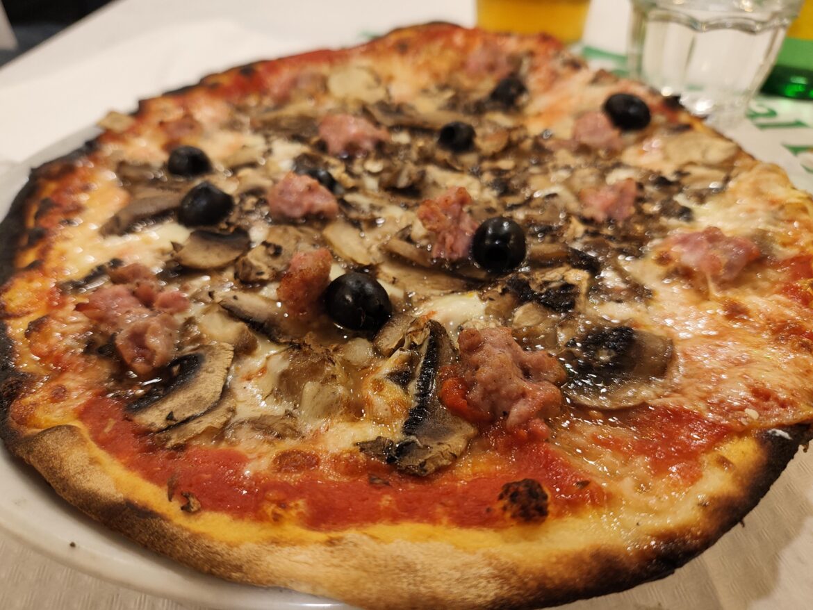 Pizza with mushrooms, salsiccia and olives, in Rome
