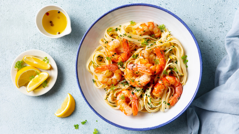 Bowl of pasta with shrimp and herbs and lemons