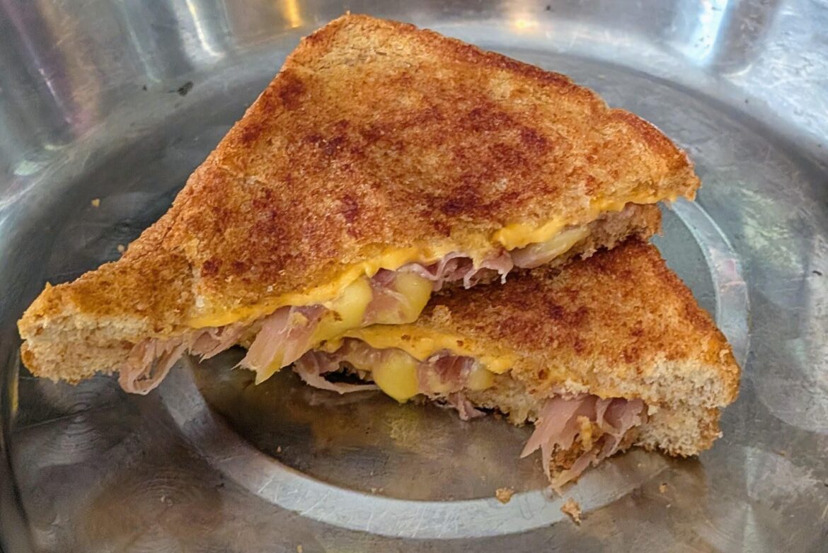 Prosciutto melt sandwich (mozzarella and American cheese) grilled on tea seed oil