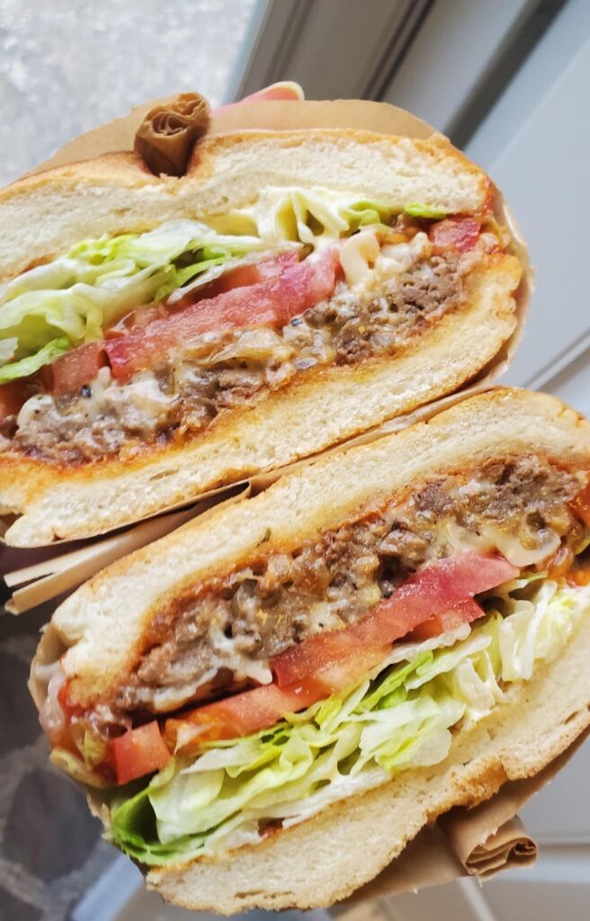 Chopped cheese on Kaiser roll. Made with ground chuck and Cooper cheese.