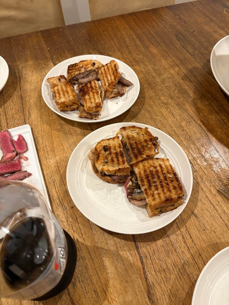 Steak, cheese, sour dough panini with grilled onions and mushrooms,