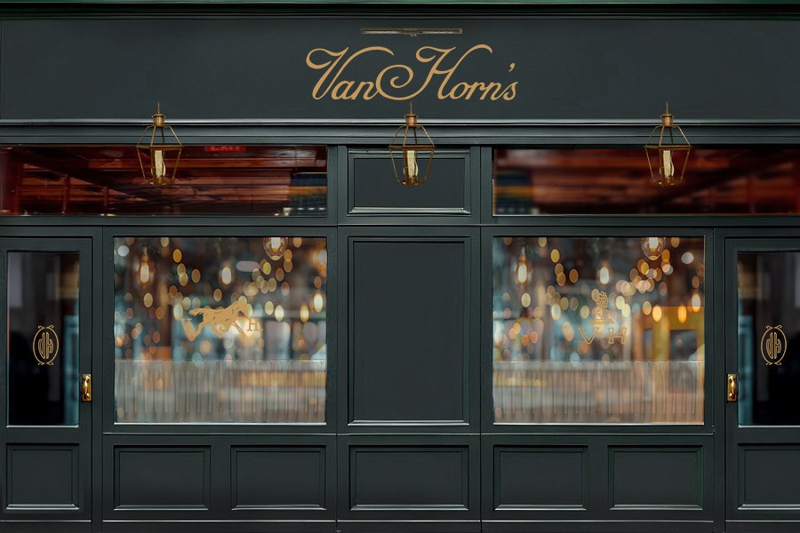 The outside off a restaurant painted a deep forest green.