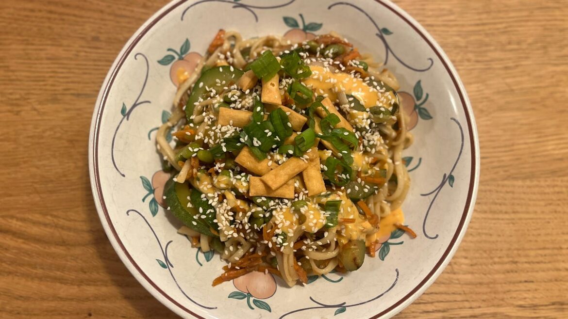 Aside From Classes, This Is the Fastest Way to Learn How to Cook a bowl of noodles with veggies on a brown table