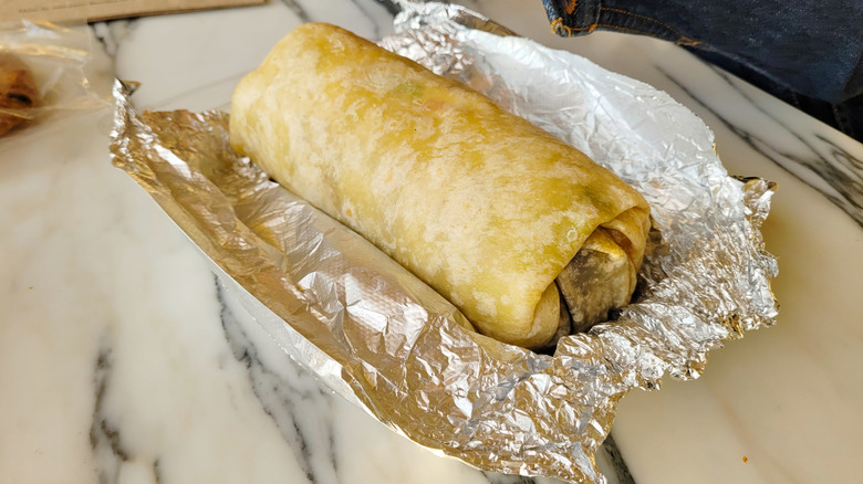 Burrito in foil on a table