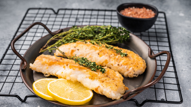 A basket of fried white cod with lemon