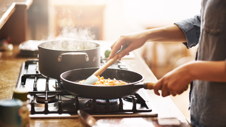cooking in kitchen in pans on stove