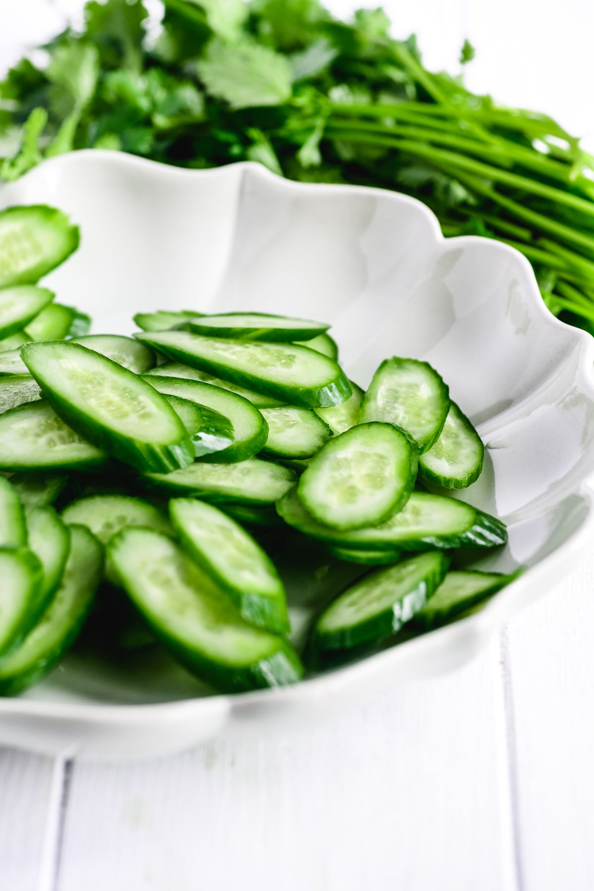 sliced cucumbers in a white bowl