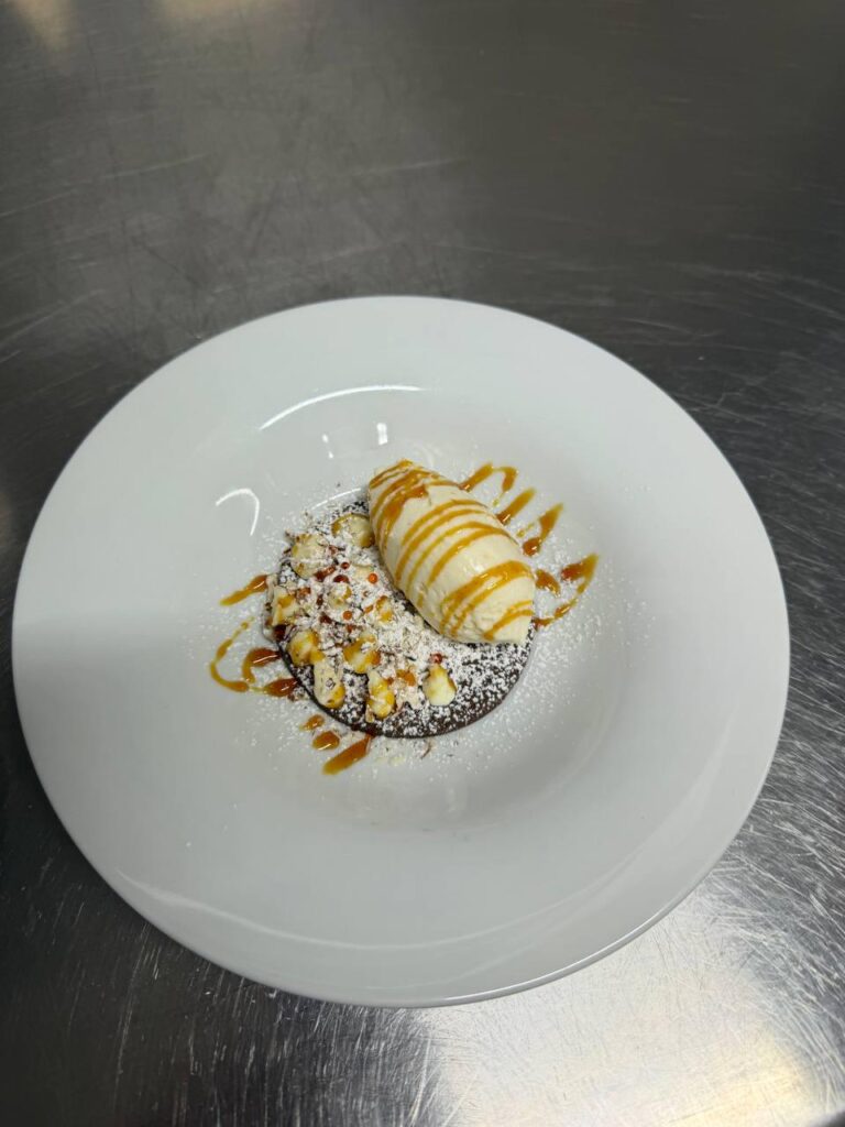 Decadent dark chocolate disk with vanilla ice cream