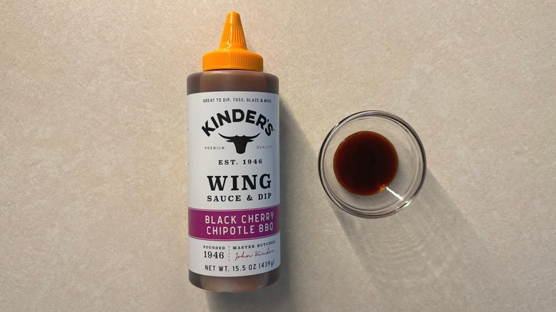Kinder's Black Cherry Chipotle BBQ Wing Sauce Dip bottle and sauce in glass ramekin