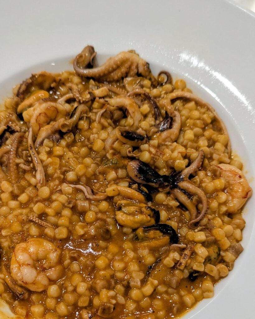 Fregula (a semolina pasta from Sardinia) with seafood and seada (a fried pastry from Sardinia filled with pecorino cheese and drizzled with honey)