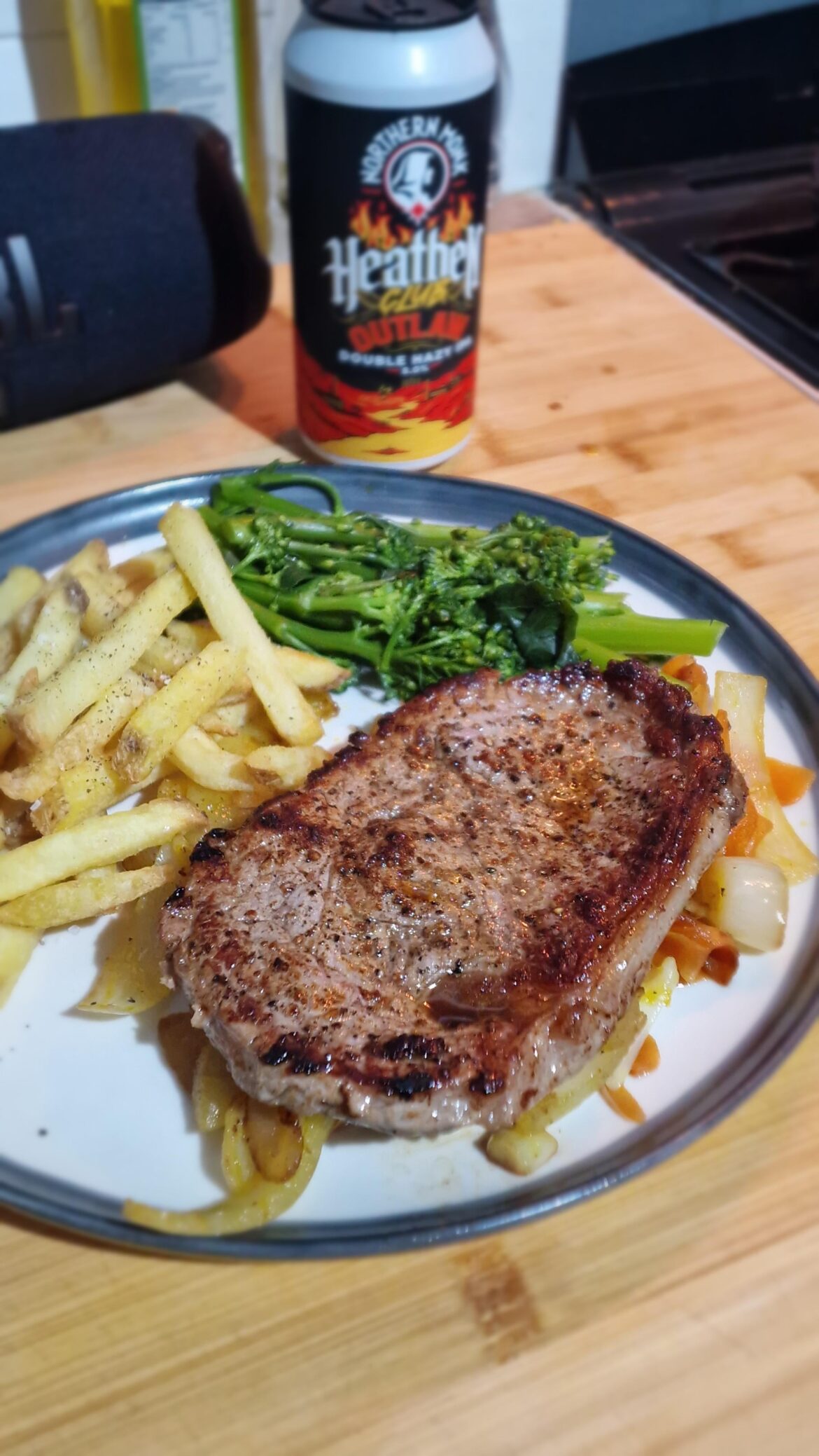 Sirloin steak on a bed of cajun spiced onions and carrots, with tenderstem broccoli and skin on fries.