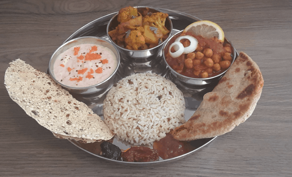 Veg Punjabi Thali: Aloo Gobi, Chole, Jeera Chawal, Gajar ka Raita