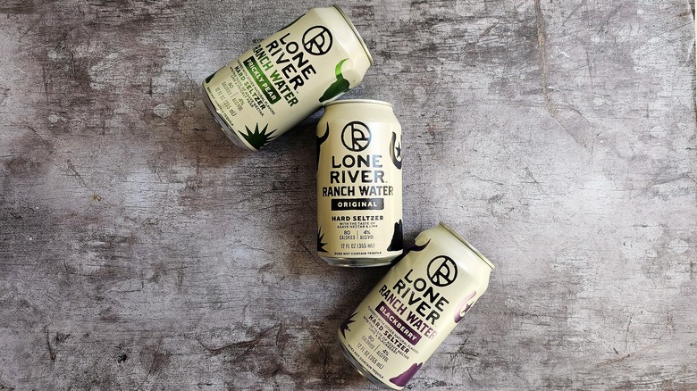 Three cans of Lone River hard seltzer laying down