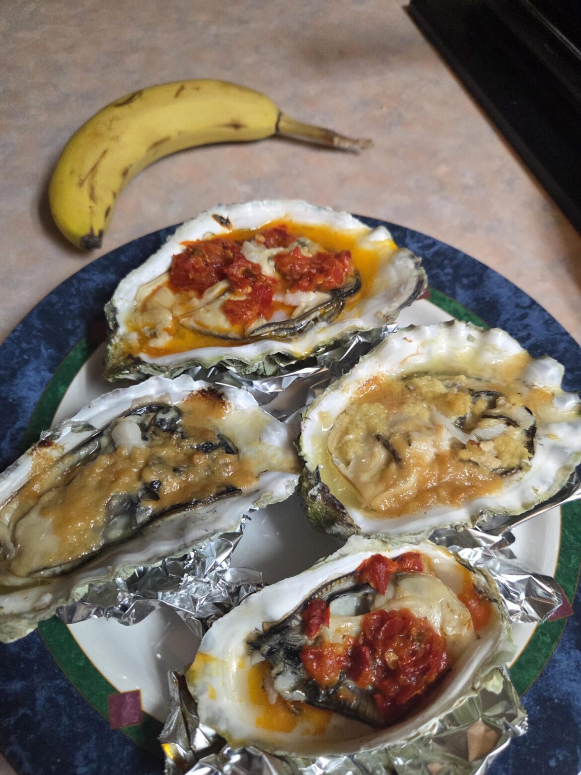 Huge fresh Alaskan oysters with miso butter and fermented chili butter