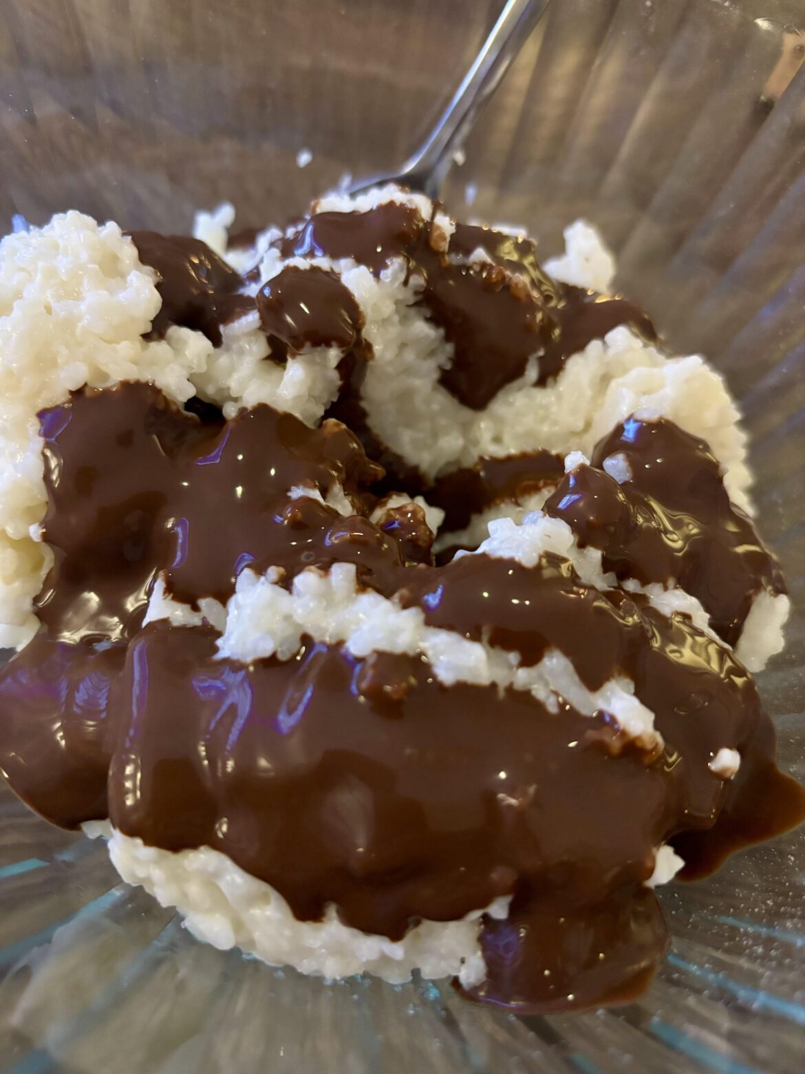 Warm coconut rice pudding, with chocolate syrup