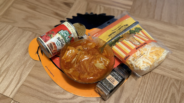 Chef Boyardee Ravioli in a bowl with shredded cheese and garlic powder