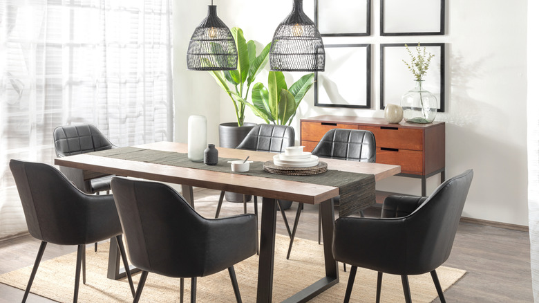 A dining room with mid-century modern chairs and a long wooden table