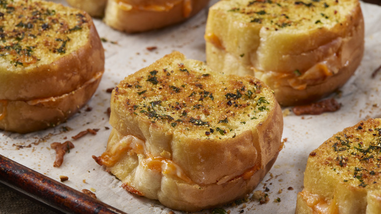 Tray of grilled cheese sandwiches on garlic bread