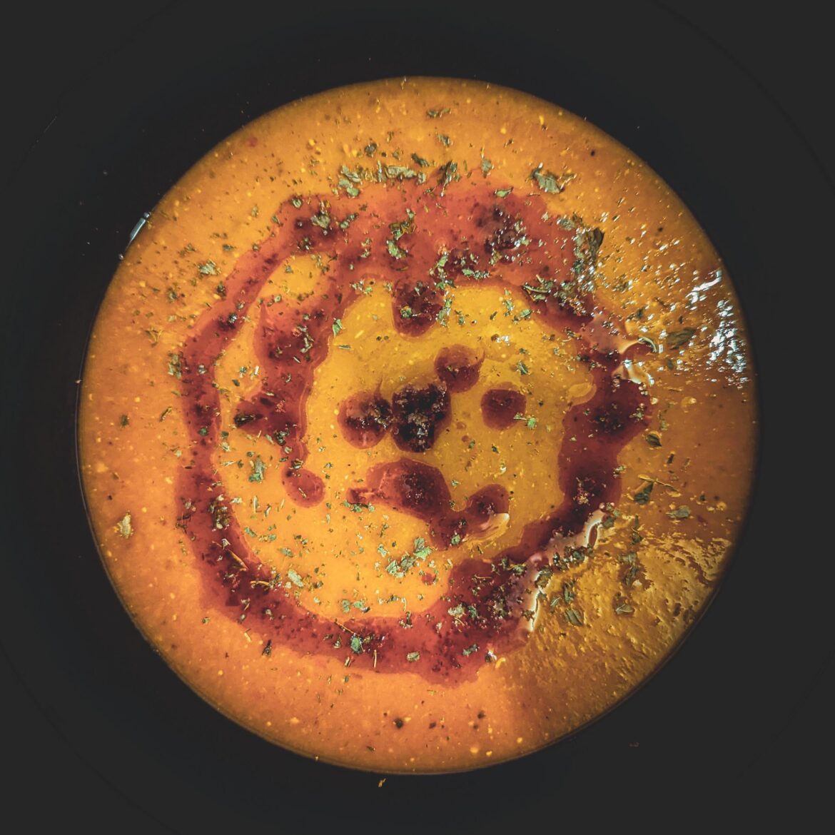 Mercimek Çorbası, a turkish soup of red lentiles with a paprika butter and dried mint as topping