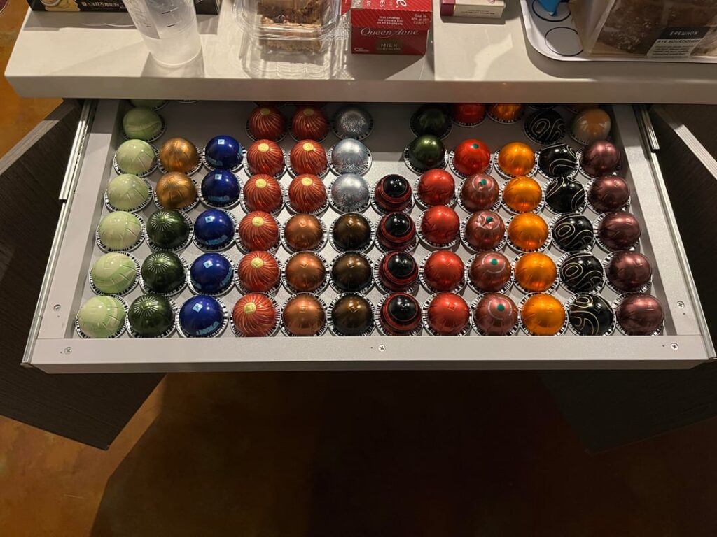 Finally! The pull-out board in the kitchen island is never used so my husband re-screwed it upside down as a pod organizer.