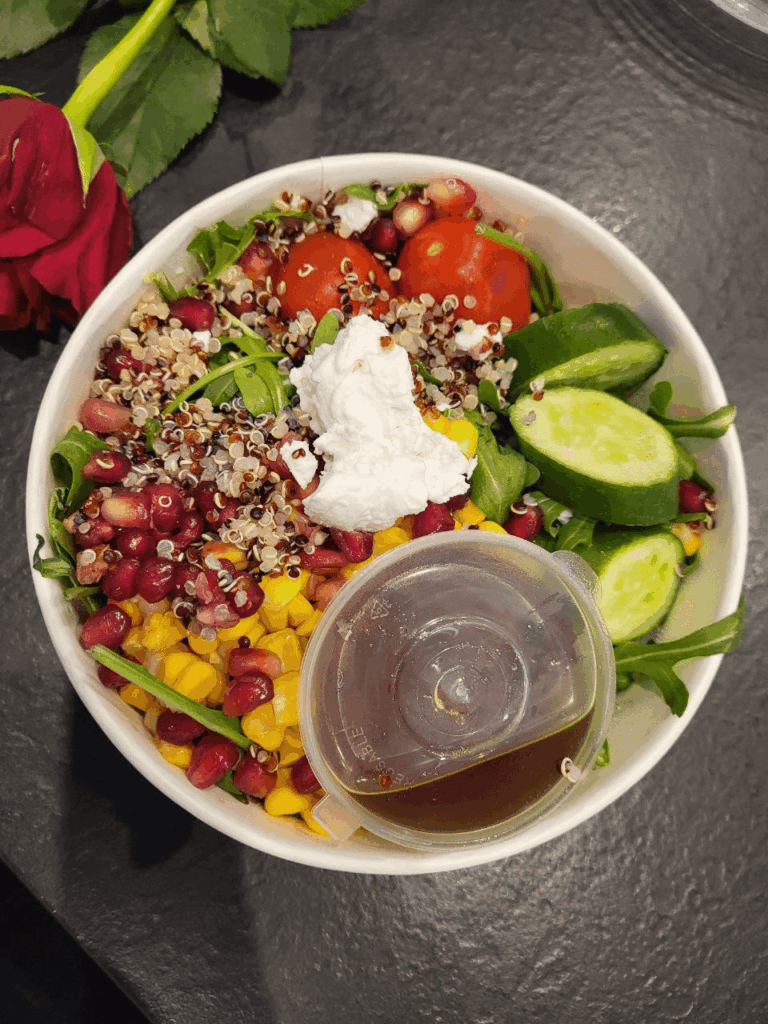 Salad with quinoa, corn, tomato, cucumber, cream cheese