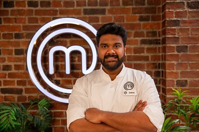 A man poses in the MasterChef studios.