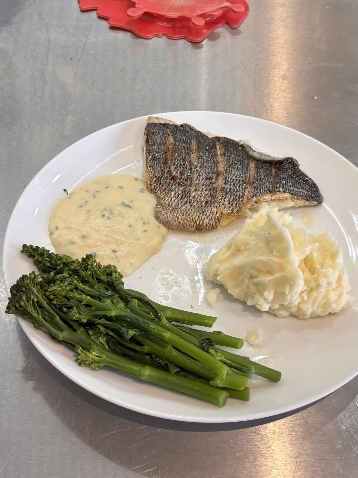 Black Bream, mash, broccoli and white sauce with chopped chives