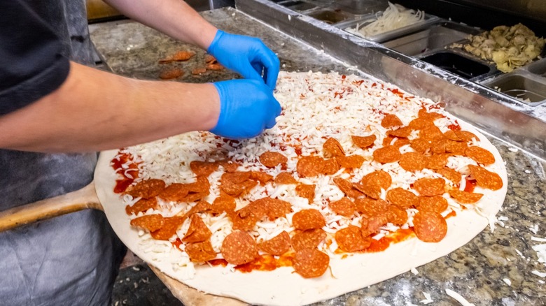 Chef preparing pizza in kitchen